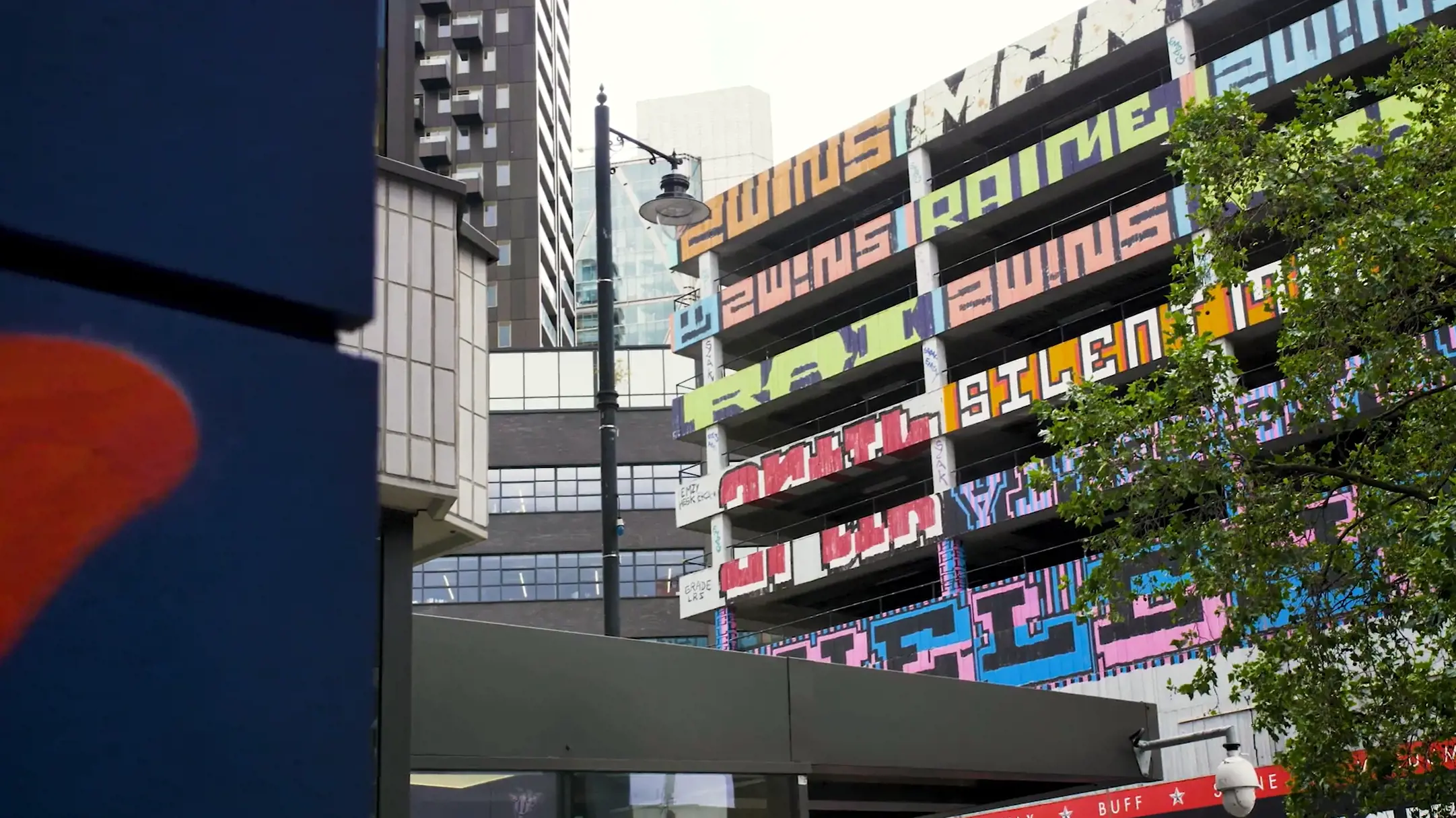 An urban art installation featuring large, colourful typography 